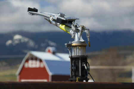 Nelson Irrigation's Big Gun® Sprinkler on a cattle ranch with big red barn in the background