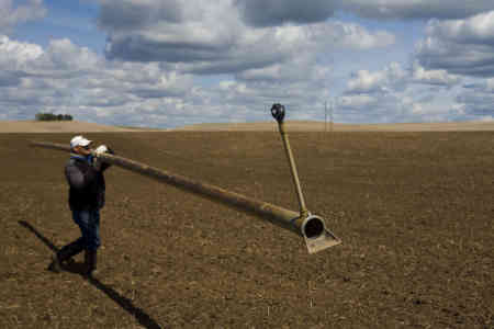 Irrigator carrying aluminum pipe with R33 Rotator® sprinkler on board