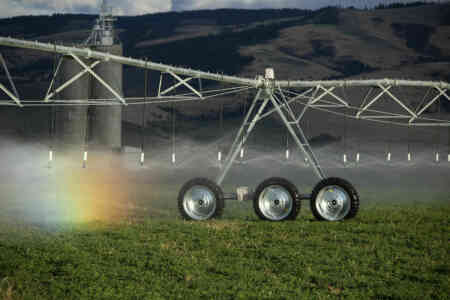 Nelson Irrigation's Rotator pivot sprinklers irrigate alfalfa on a field at the base of the Blue Mountains in Walla Walla
